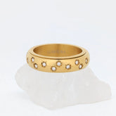 Allura Fidget Ring van goud edelstaal met bloemgravure en kleine steentjes – Luminora