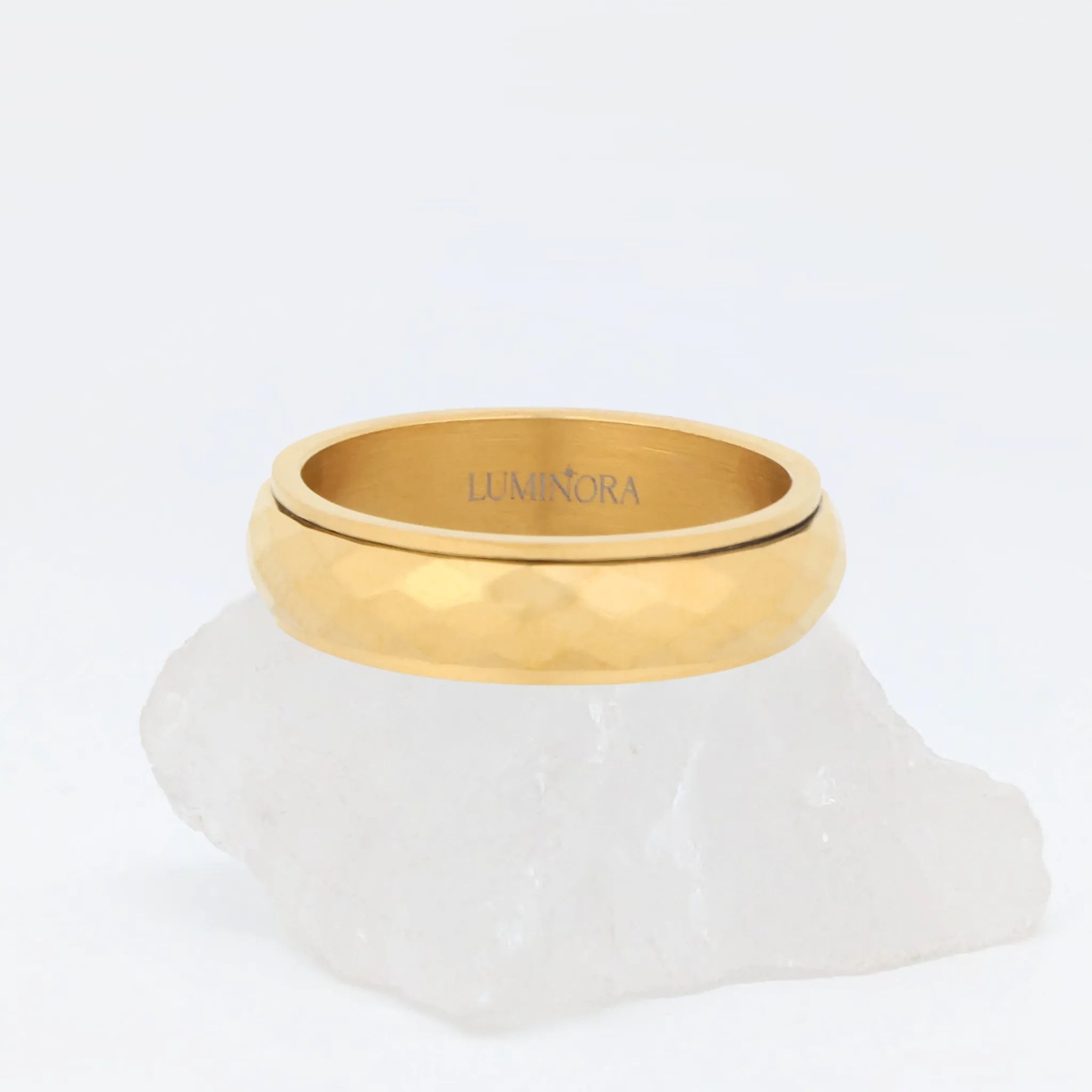 Gouden Nova anxiety ring van stainless steel met gehamerd profiel, packshot op lichte achtergrond – Luminora