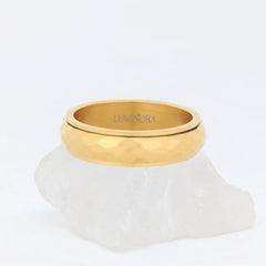 Gouden Nova anxiety ring van stainless steel met gehamerd profiel, packshot op lichte achtergrond – Luminora