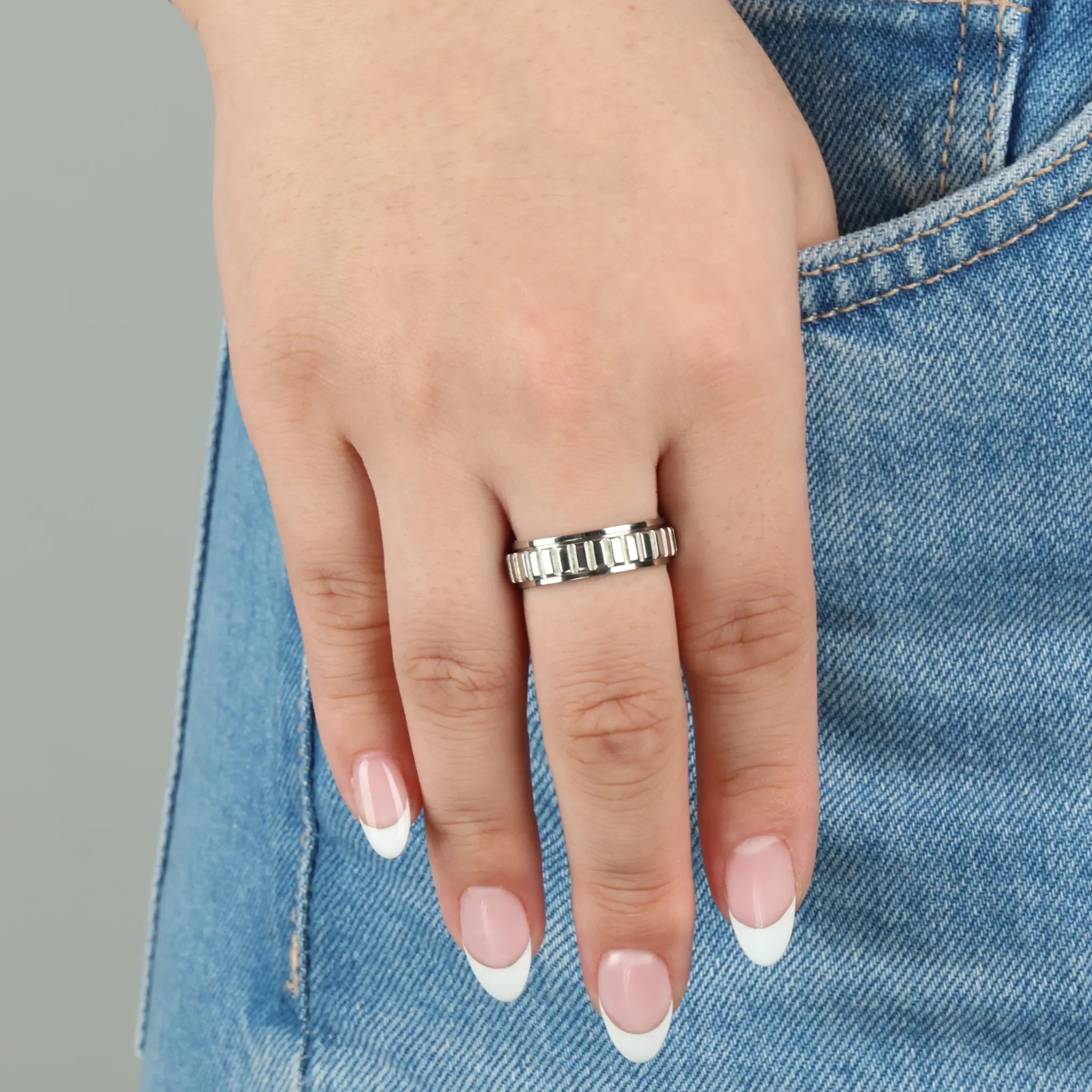 Zilveren Arden fidget ring met ribpatroon - vrouw met spijkerbroek - Luminora