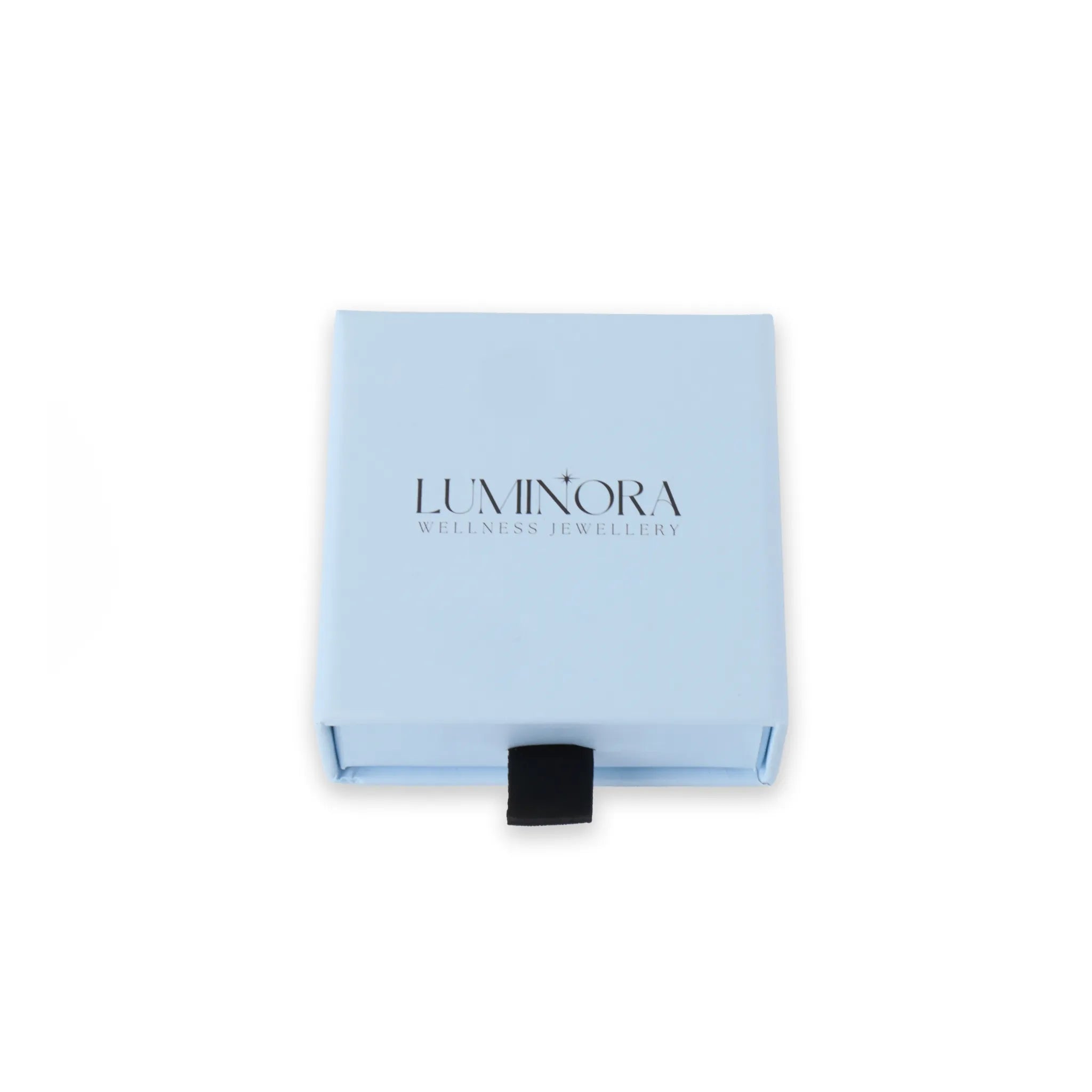 Kleine Luminora cadeauverpakking van 7x7 cm in lichtblauw, luxe sieradendoosje met zwart lint en Luminora-logo – ideaal voor fidget ringen en wellness sieraden