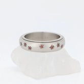 Luxe Sienna fidget ring van edelstaal met glanzende afwerking, bloemgravure en robijnrode stenen – Luminora