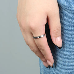 Vrouw draagt zilveren Lila fidget ring op spijkerbroek, ideaal tegen stress – Luminora