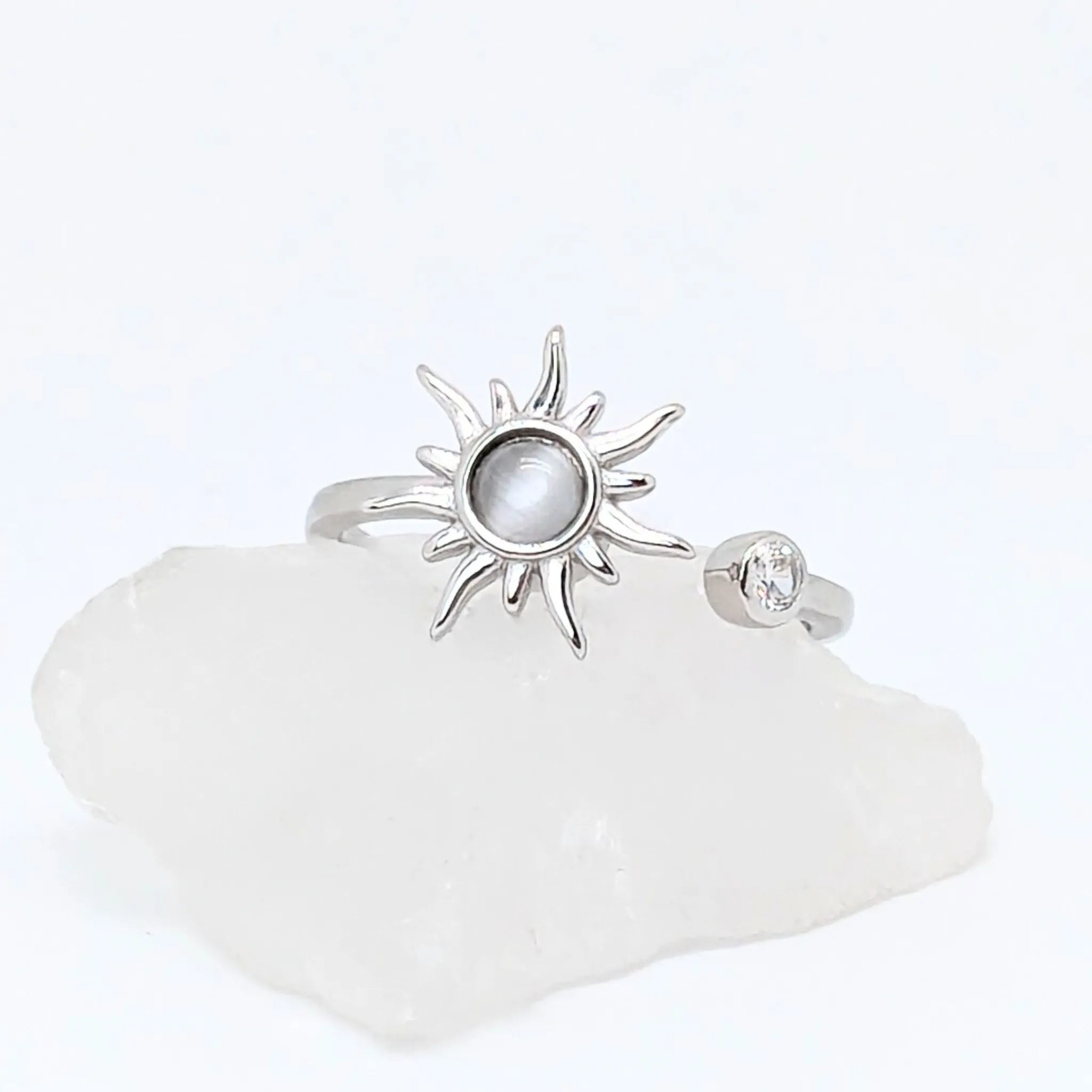 Close-up van verstelbare zilveren Solar wellness ring met zonvormig design en glanzende steen – symbool van energie en innerlijke rust