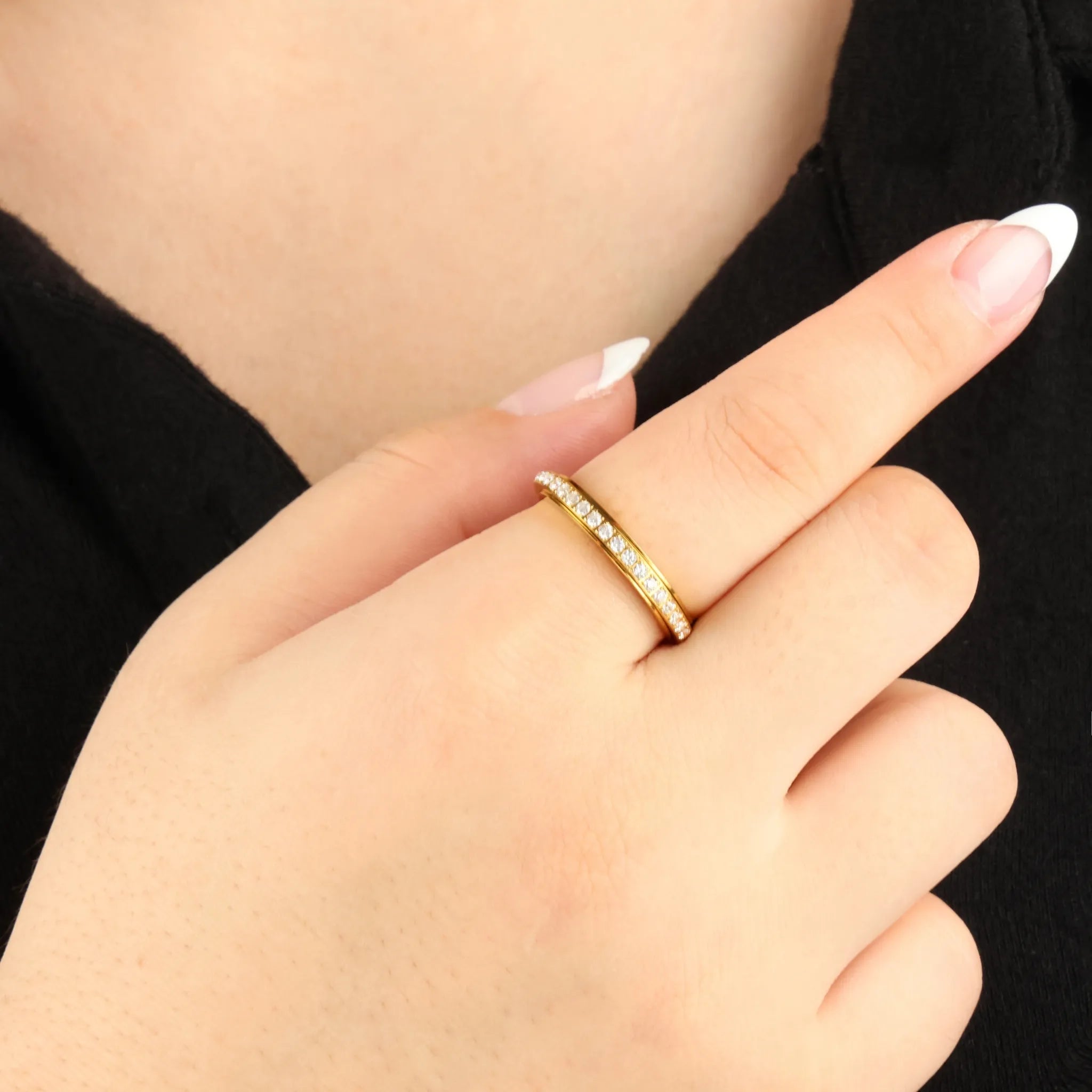 Haven anxiety ring in goud met kristallen, gedragen aan hand bij zwarte outfit – Luminora